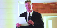 John saying a speech at his sons wedding.